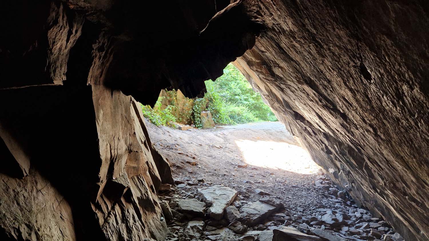 A view from inside the dark cave-like structure at Forest Rock, out into the sunshine