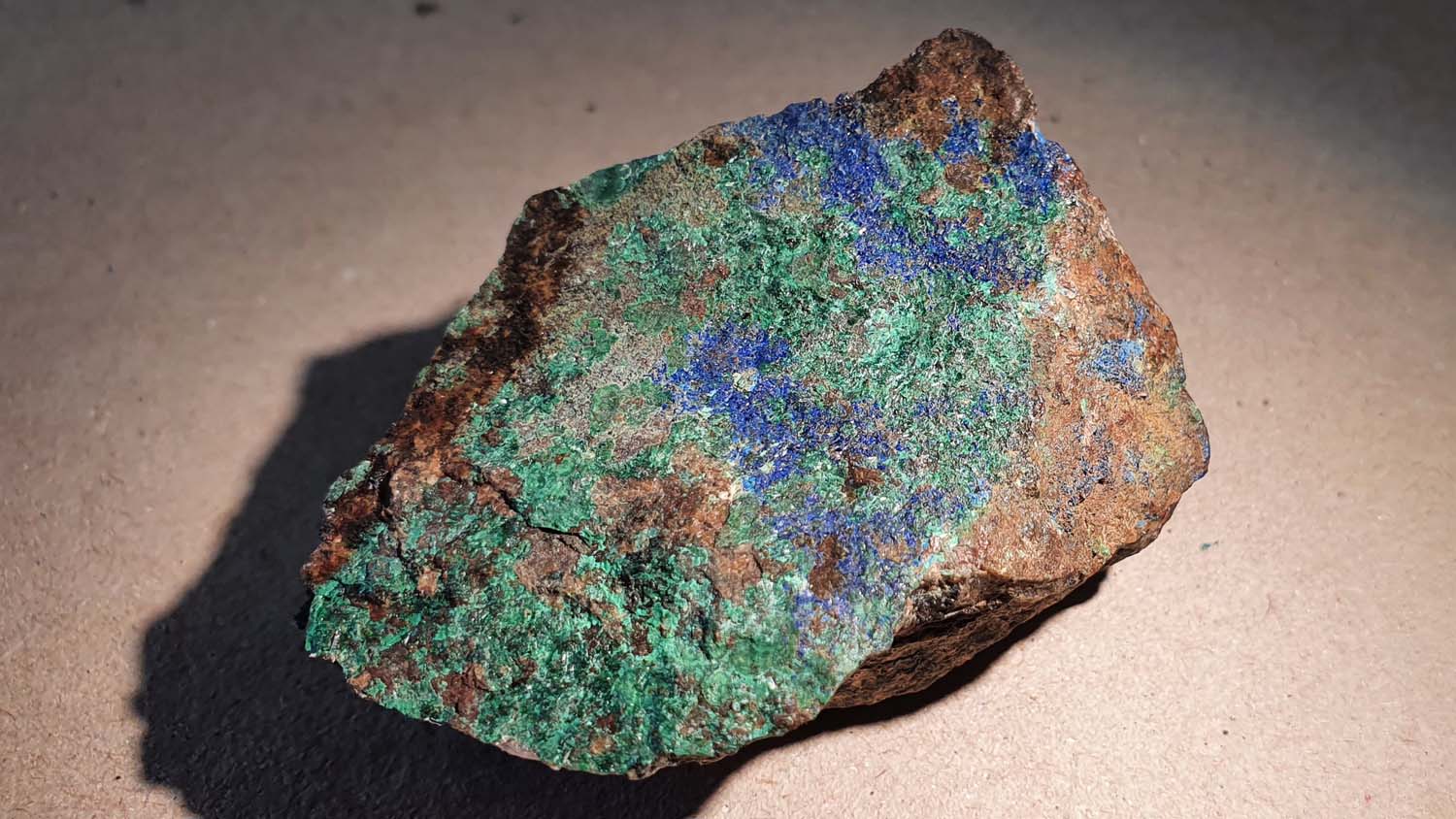 A small specimen of colourful green and blue minerals from Charnwood Forest. (c) OUMNH