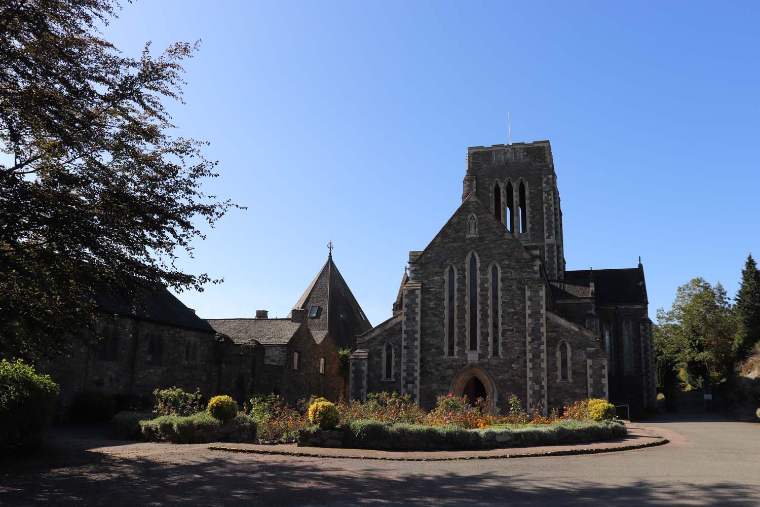 A view of Mount St. Bernard's Abbey with a blue sky background.