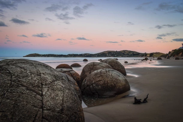 Large spherical boulders on an area of sandy beach