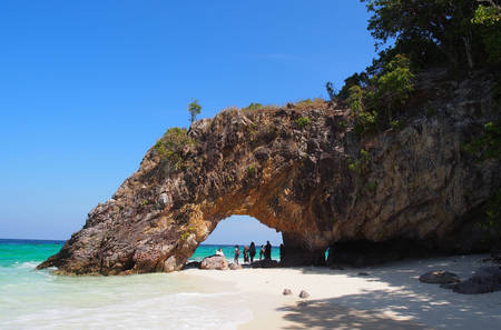 A sea arch in an area of tropical coastline