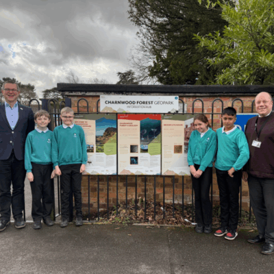 Staff and children standing next to the Information Hub at Broomleys